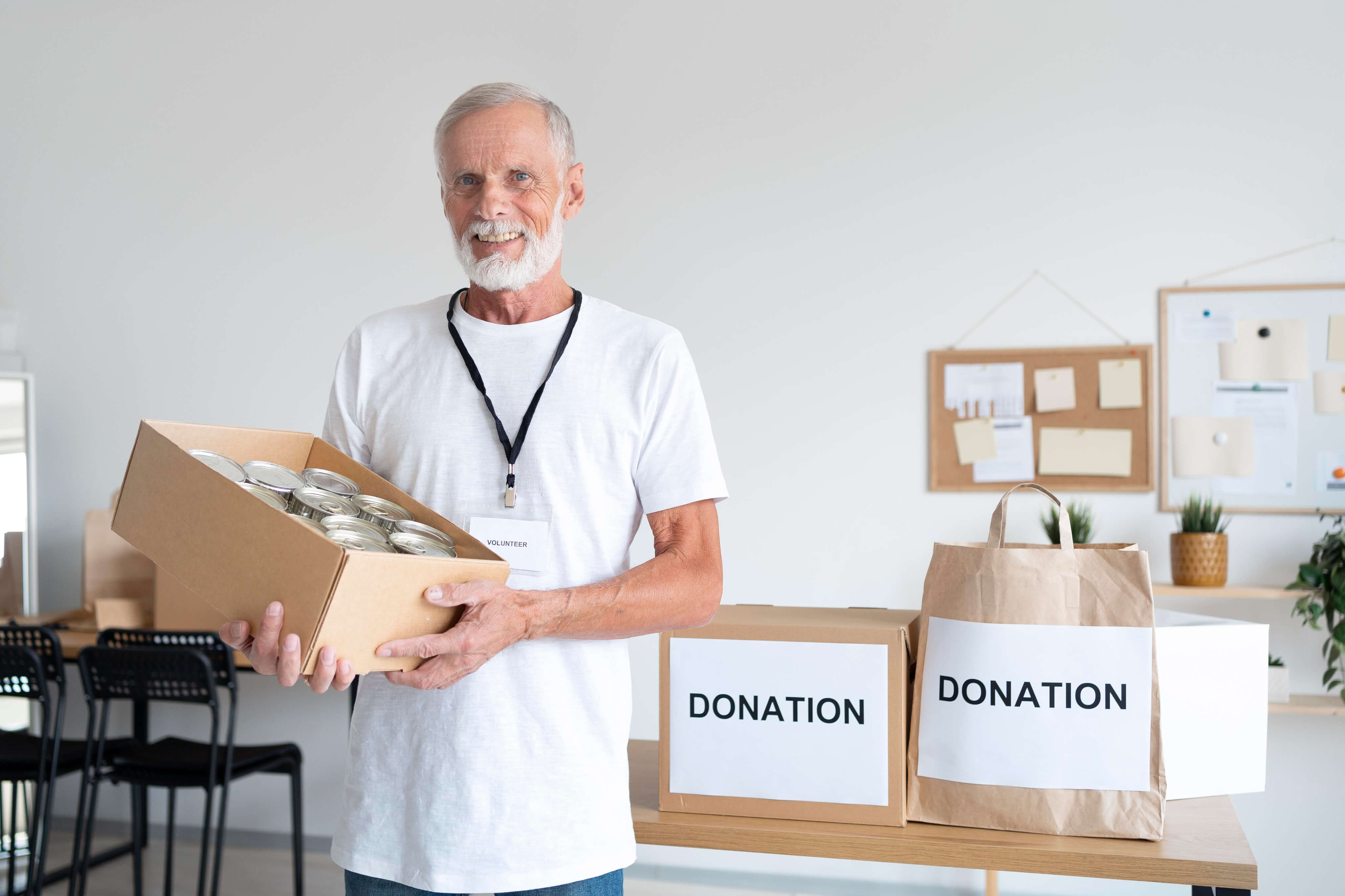 Four smiling children wearing gloves and raising thumbs up behind recycling boxes filled with paper and plastic.